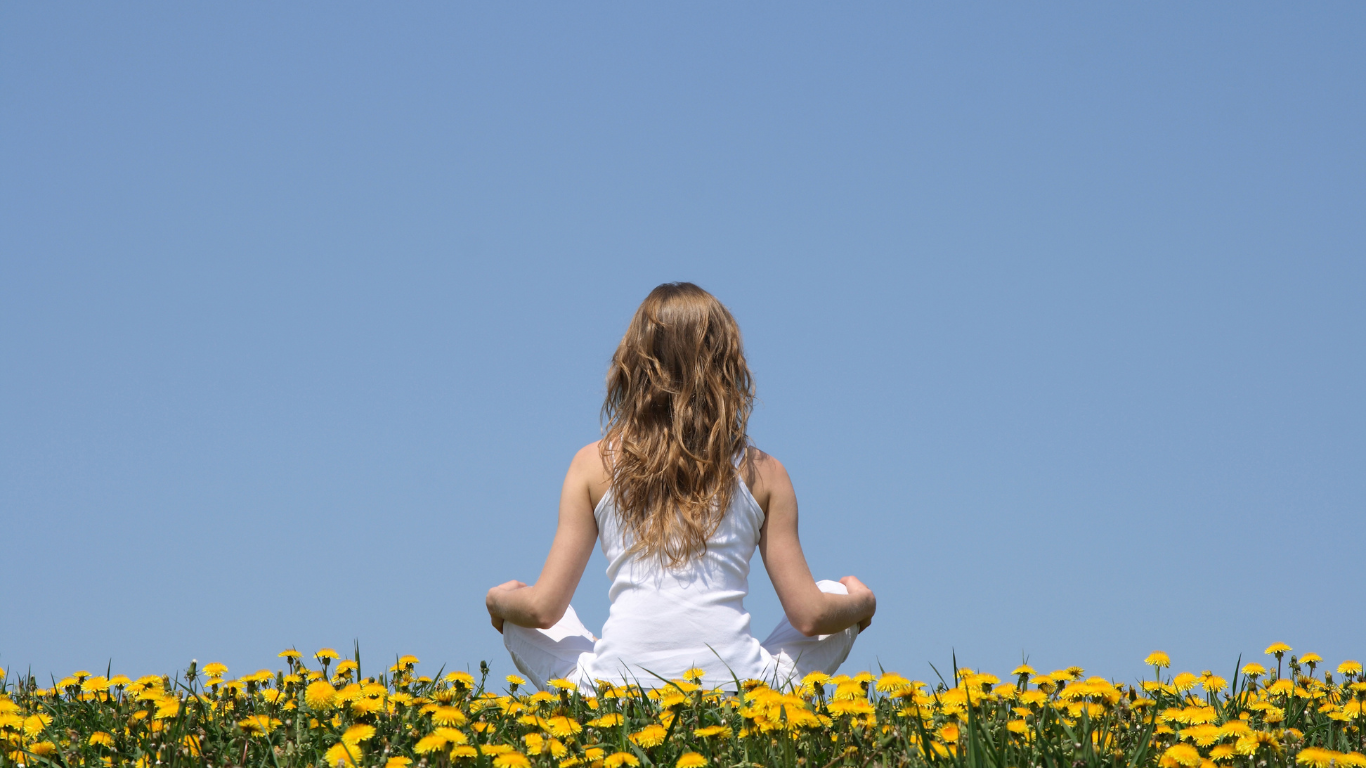 girl meditating in field